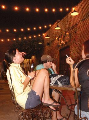 Claire Pivach, an animal science senior, and Tim O'Brien, an Accounting senior, laugh with friends outside of SoGo Live Friday night. SoGo will stay open in its present location for the duration of the appeal.