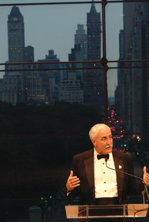 Chancellor Sean O'Keefe addresses a crowd of more than 250 June 19 at the Lincoln Center, backed by the New York City skyline.