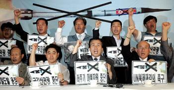 South Korean right-wing activists shout slogans during a rally against the North's test-firing of seven missiles in Seoul on Monday.