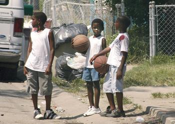 Charles Banks, 11, Devin, 8, and Nakeem Martin, 8, stand on Devin Street in the Goose neighborhood in New Orleans. All of the homes in the area were severely damaged by Hurricane Katrina and FEMA trailers sit outside many homes.