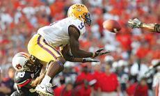 Junior wide receiver Early Doucet dives to catch a pass while being tackled by Auburn defensive back Zach Gilbert. The SEC ruled Monday that the officials' decision of no pass interference on the play was correct.