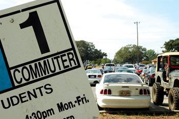 A crooked sign guards the entrance to a jam-packed commuter parking lot off Nicholson Drive. Students are expected to catch a break with the reopening of the West Stadium Parking lot which will provide more than 500 additional spaces.