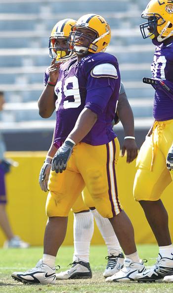 Sophomore Marlon Favorite (center) looks toward the sideline at practice March 25. Favorite and UL linebacker Jonathan Vance were teammates in high school.