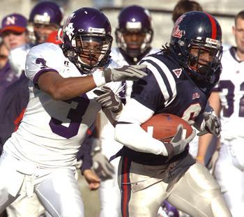 Ole Miss' BenJarvus Green-Ellis (right) is run out of bounds Nov. 4 by Northwestern State's Russ Washington (3) in Oxford, Miss.