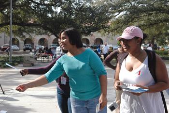 Black Student Union members Sadie Becnel, political science sophomore, and Courtney Smith, biological sciences sophomore, hand out fliers Monday afternoon in Free Speech Plaza. The BSU is informing students about Know AIDS Week.