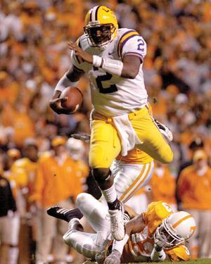 JaMarcus Russell hurdles Tennessee defensive back Jonathan Hefney as he scrambles for extra yardage in the second half Saturday in the Tigers' 28-24 victory over the Tennessee Vols in Knoxville, Tennessee.