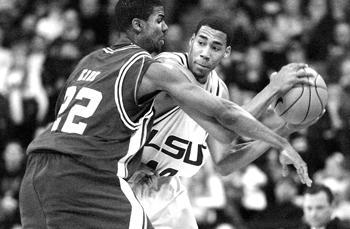 LSU sophomore guard Garrett Temple tries to pass the ball Tuesday while being defended by Texas A&amp;M University guard Dominique Kirk in the Tigers' 64-52 win over the Aggies in the PMAC.