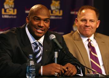 JaMarcus Russell speaks to the press next to Coach Less Miles Wednesday after announcing he will enter the NFL draft.