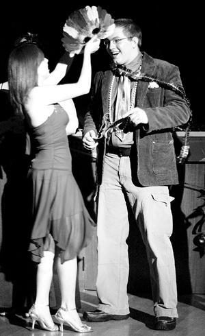 Amy Vitrano, mass communication freshman, crowns Jeremy Chinier, biological science junior, king of the Fifth Annual Mardi Gras Ball in the Union Ballroom on Thursday night.