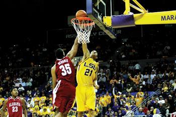 LSU sophomore center Chris Johnson attempts a dunk Wednesday over Alabama's Richard Hendrix in the Tigers 73-70 loss in the PMAC. Johnson scored 13 points in his first start.