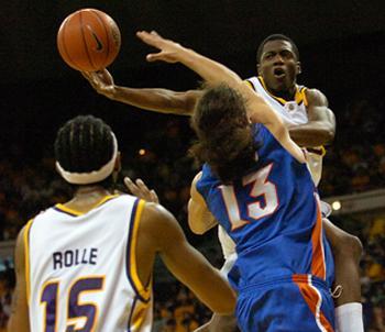 Florida's Joakim Noah goes up for the block as Dameon Mason passes the ball to Magnum Rolle in the first half. The Tigers defeated the Gators 66-56.