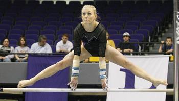 LSU senior Kelly Phelan performs on the uneven bars Friday night in the Tigers' 197.025-143.750 win against the University of Nebraska. Phelan won the balance beam event for the Tigers with a 9.900 in her final meet in the PMAC.