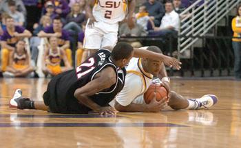 LSU junior forward Glen Davis peers under the arm of a University of South Carolina defender Saturday in the Tigers 61-52 victory in the PMAC. Davis was named a finalist for the Wooden Player of the Year Award.