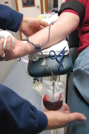 At the Our Lady of the Lake medical van Jill Mcintyre, a blood donor technician, administers a needle to the arm of a University student. The vans only take one pint of blood, which can save three lives.