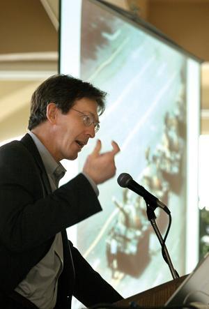 Robert Hariman, Northern University professor, speaks Tuesday in the Atchafalaya room of the Union. Hariman delivered a lecture on iconic photography centered around the Tianamen Square photograph, featured in the background.