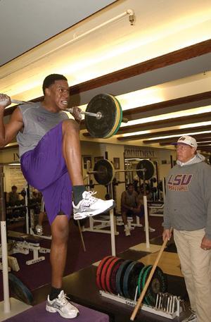 LSU men's basketball forward Tasmin Mitchell does weight training exercises Wednesday afternoon while strength and conditioning coach Gayle Hatch looks on in the Center for Athletic Training.