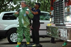 Two members of the BRPD fire department prepare to enter Sturgis Hall on Tuesday after a bottle of nitric acid likely caused a fire in the building. No major injuries were reported.