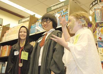 Sophie Sheffield (right), dressed as the house-elf Dobby, shows her excitement for the release of Harry Potter and the Deathly Hallows at Barnes and Noble with her older sister Ana Sheffield (left) and friend Amy Zhao (center). According to the book's publisher, Scholastic, the seventh and final installment in the series sold 8.3 million copies in the U.S. within the first 24 hours of sales.