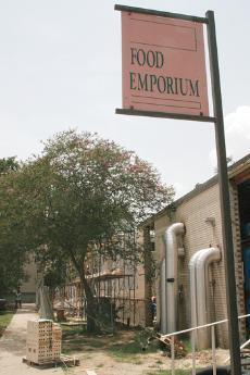 The Laville Food Emporium sign stands outside the now gutted building while it undergoes construction. The building will house a Taco Bell and Pizza Hut when it opens this fall.