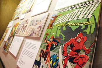 A Daredevil comic book sits among other antique issues in Hill Memorial Library's history of comics display. Recent movies adapted from classic comics have renewed public interest in the childhood pastime.