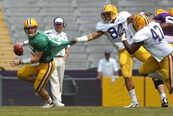 Quarterback Matt Flynn escapes sophomore posistion. Rahim Alem (84) and junior Tremaine Johnson (47) pass rush during the March 24 spring game.