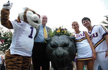 Mike the Tiger, LSU Chancellor Sean O'Keefe, and LSU cheerleaders pose around the statue of LSU's mascot during the university's official mascot naming ceremony on Friday. The ceremony, held in honor of the new Mike, featured guest speakers and refreshments.