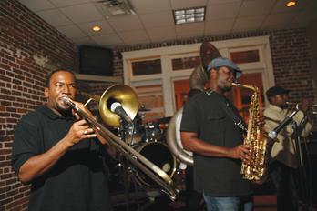 A member of the Michael Foster Project plays trombone during The Michael Foster Project's benefit performance at Avoyelles on Thursday night. Proceeds from the show were donated to Literacy Works, a Baton Rouge organization to teach illiterate adults and families.