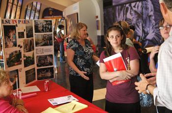 Jeffrei Clifton (left), mass communication junior, and Heather Grosso, elementary education junior, talk to an adviser at the LSU in Paris booth at the Study Abroad Fair on Thursday afternoon. The Study Abroad Expo was held in the PMAC.