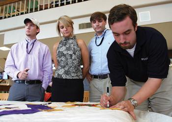 Student Government members sign the Virginia Tech quilt on Wednesday afternoon in the Student Union.