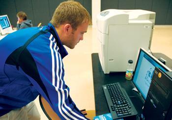 Garrett Zollinger, general studies senior, uses one of the printers in Middleton Library on Monday night.