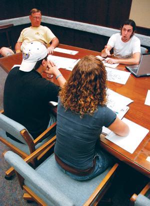 Moshe Cohen (top right), mathematics graduate student, speaks Monday at a meeting with Student Government senators Meghan Hanna (bottom right) and Andrew Remson (bottom left) and associate librarian Mark Martin (top left).