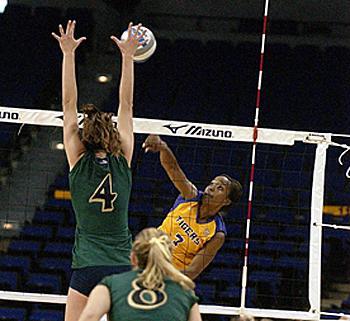 Kyna Washington, junior outside hitter, hits the ball over Notre Dame's Serinity Phillips during the matchup Tuesday in the PMAC. The Tigers defeated the Fighting Irish in the fifth game of the match.