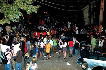 Costumed partygoers fill Carlotta Street during this past year's Halloween party. The annual celebration typically draws large crowds.