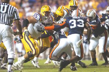 LSU sophomore offensive guard Lyle Hitt (65) takes on Auburn senior strong safety Eric Brock (33) during the Oct. 20 game in Baton Rouge.