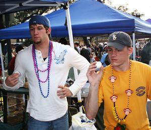 Caleb Trisler (left), kinesology sophomore, and Steven Johnson (right), business management junior, play beer pong February 9 during Mardi Gras in New Orleans. Many people say they do not think about the health risks of beer pong. Photo by J.J. Alcantara/ The Daily Reveille