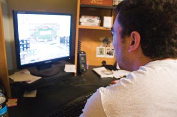 Eric Wilderotter, accounting senior, plays a game of poker on his computer as a way to earn extra money while in college.