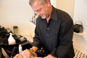 Joel Dyer of Salon Londyn gives a customer a "blowout" Wednesday. Women are washing their hair less and going to salons more for blowouts.