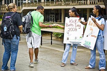 Student advocates Ta'Nyeka Ingram, biology junior (middle), and Margaret Manns, anthropology sophomore (far right), hand out information Tuesday to students on how to quit smoking in Free Speech Alley. Media Credit