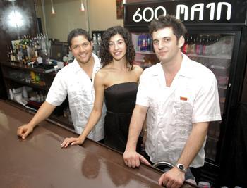 Jeremy Meighan (left), Sara Meighan (middle) and Danny Breaux (right) stand behind the bar of 600 Main, a new local club.