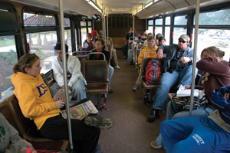 Students sit and wait on a bus headed for Tiger Land this past fall semster. Student Government officials plan to cut from both the Greek and Tiger Land routes.