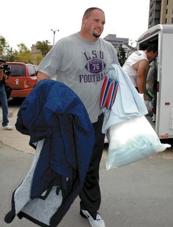 Former offensive tackle Andrew Whitworth gives a hand to a family that evacuated in 2005 from the New Orleans area after Hurricane Katrina.