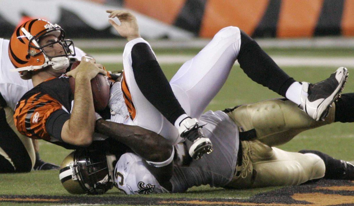 Cincinnati quarterback Jeff Rowe (top) is sacked by New Orleans defensive end Bobby McCray (bottom) during Saturday&#8217;s preseason game in Cincinnati.