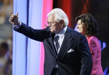 Sen. Edward M. Kennedy, D-Mass., gives a thumbs up at the crowd as wife Victoria Reggie looks on as the go on stage at the Democratic National Convention in Denver, Monday, Aug. 25, 2008.