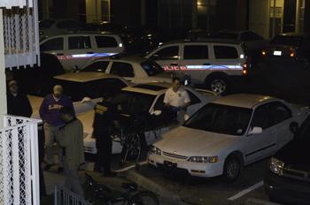 Coroner's Office officials remove a body from Edward Gay apartments on Dec. 13. University graduate students Chandrasekhar Reddy Komma and Kiran Kumar Allam were murder in the on-campus apartment complex. Police officials say there's a steady flow of progress being made in the case.