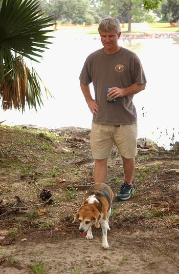 Greg Mondello, Kenner resident, walks his dog, Maggie, around the University lakes as he prepares to weather the storm. Modello, like many others, are staying with their children who attend the Universty.