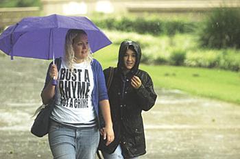 Students walk through the rain Sunday as the remnants of Tropical Storm Fay hit the Baton Rouge area.