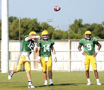 Lee throws a pass as sophomore quarterback Andrew Hatch and freshman quarterback Jordan Jefferson watch.