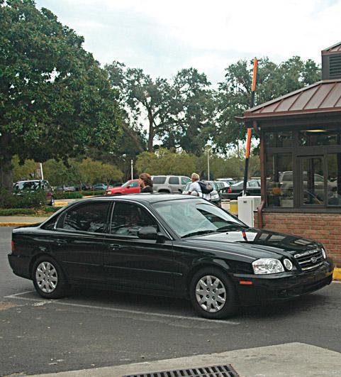 A car passes through the manned Easy Streets booth near Infirmary Road on Tuesday afternoon. Since the implementation of Easy Streets, on-campus traffic and accidents have decreased.