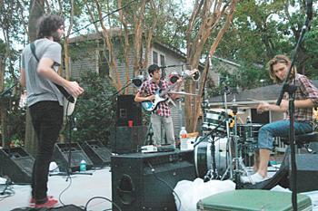 Evan Hendrix on bass, Shay Youngblood on lead guitar and Hank Fontenot on drums perform Saturday on Ivanhoe Street.