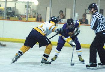 Brandon Hicks (middle) faces off against Vanderbilt in the hockey match Saturday afternoon. The Tigers defeated the Commodores 7-5.